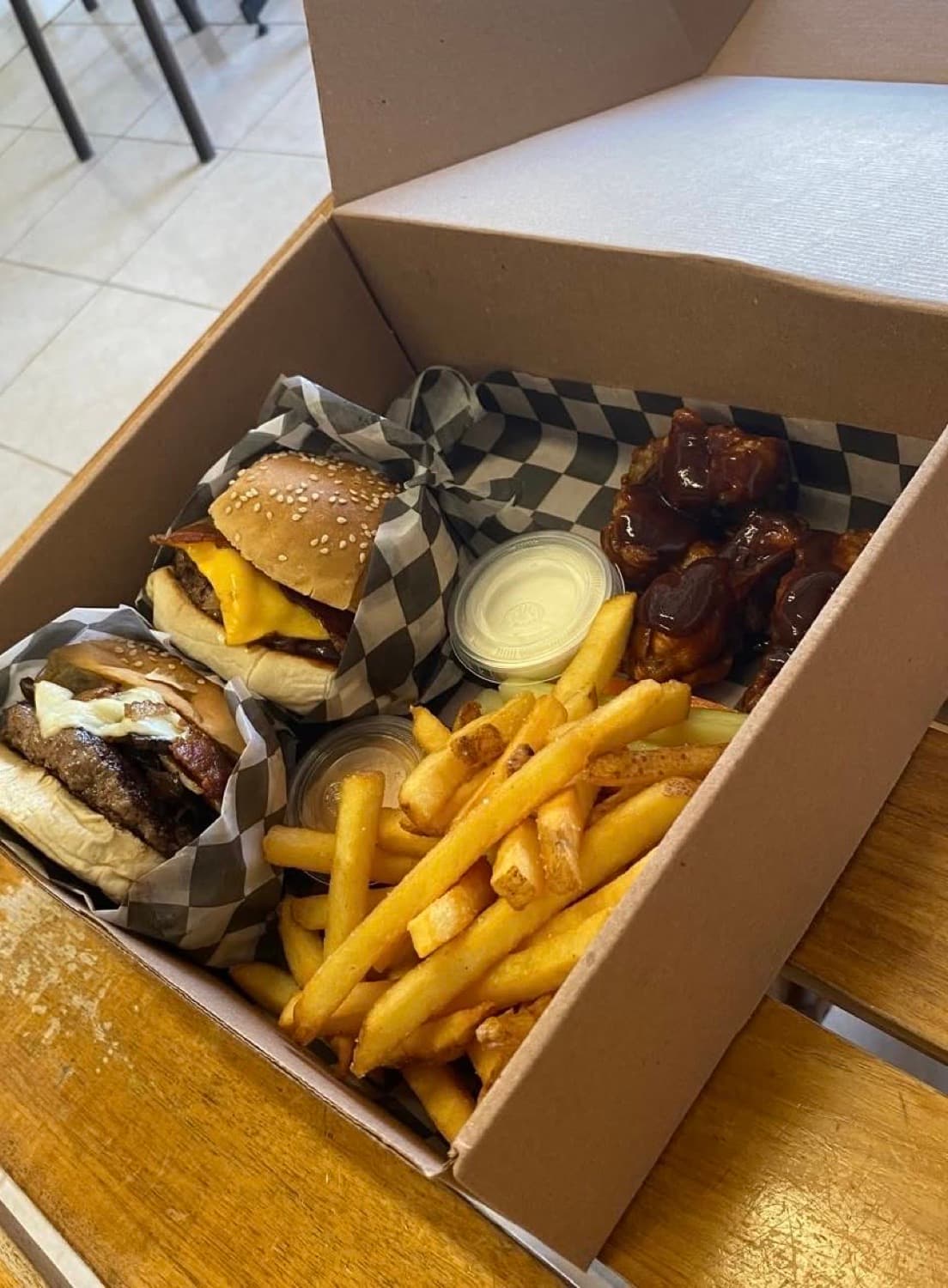 An open Burger Underground box: two burgers, fries and wings