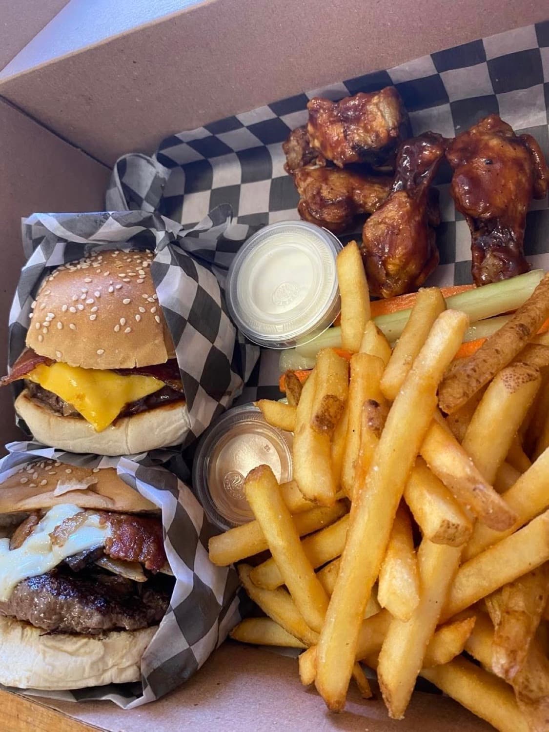 A Burger Underground box from above: two burgers, fries and wings